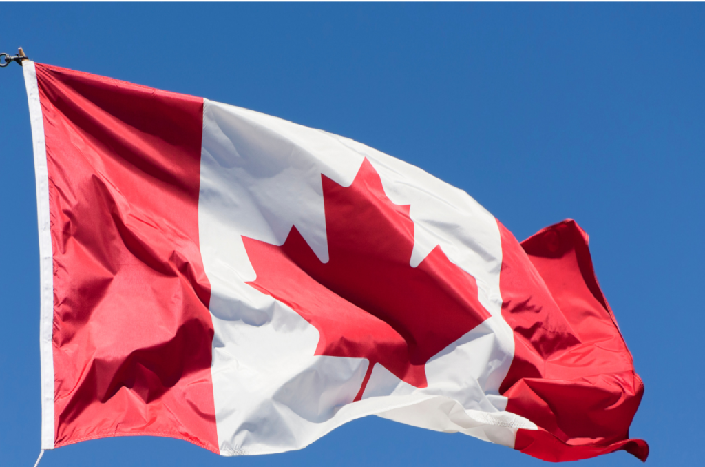 Canadian Flag waving in the blue clear sky